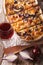 Flammkuchen sliced pie and red wine close-up. Vertical