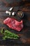 Flank, Bavette steak with seasonings, and fresh herbs raw meat, marbled beef . Dark wood rustic background. Top view