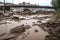 flash flood brings debris, mud and other pollutants into river