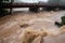 flash flood engulfs bridge, with cars and people swept away in raging waters