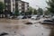 flash flood hits a town, with buildings and cars submerged in water