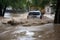 flash flood rushes through town, taking with it debris and vehicles