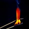 Flashed and burning wooden match on a dark background close-up. Bright fire and smoke from a burning tree