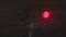 Flashing red traffic light at a railway crossing at night