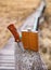 Flask and knife on wooden surface