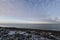 Flat arctic landscape in late fall with snow on the ground and blue skies