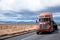 Flat bed semi truck transporting cargo under cover on California