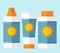Flat bottles of sunscreen with sun motif
