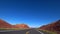 Flat California road. Desert landscape outside the car window. Bright sunny day. Death Valley California.