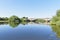 A flat calm River Trent flowing under Gunthorpe Bridge