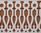 Flat carved white balusters made of wood on a dark background. East Siberian ornament