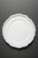 flat ceramic plate white on dark background generated by ai