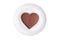 Flat chocolate heart on a saucer on a white backgr