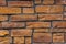 flat close-up full frame background and texture of decorative orange stone bricks