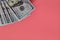 Flat closeup of dollars on pink background. Investment profit income. Success concept. Finance investment concept. Dollar sign.