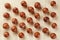 Flat composition with Australian macadamia nuts on bamboo light background. Patterns, repetitions