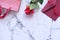 Flat composition of rose, envelope and gift on tile background