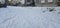 A flat field covered with deep snow and a person\\\'s footprints