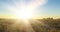 Flat hill meadow time lapse at the summer sunrise time. Wild nature and rural grass field. Sun rays and green trees