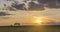 Flat hill meadow time lapse at the summer sunset time. Wild nature and rural field. Sun rays, trees, green grass movement