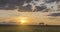 Flat hill meadow timelapse at the summer sunset time. Wild nature and rural field. Sun rays, trees, green grass movement