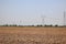 Flat land, dry land, rural Asia, large power transmission towers  Beautiful sky background