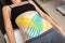 Flat lay above view applying blue adhesive elastic therapeutic tape on female abdominal muscle of young adult slim