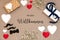 Flat Lay With Accessories, Gifts, Hearts, Text Herzlich Willkommen Means Welcome