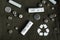 Flat lay with alkaline batteries on dark green background. Recycling chemical waste, environment and ecology saving concept.