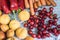 Flat lay of apricots, tomatoes, cherries, carrots, and red bell peppers on a table napkin