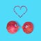 Flat lay arrangement consist of two pomegranates with pomegranate`s seeds form heart shape on the pastel blue background. Used