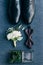 flat lay with arrangement of grooms shoes, bow tie, corsage and wedding rings for rustic wedding