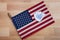 Flat lay background with one American flag with one sketched heart on torn white paper