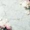 Flat-lay of Beautiful peony flowers over vintage marble background, top view, copy space