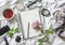 Flat lay beauty products background. Notepad, rose, perfume, mascara, watches, glasses, headphones, phone, scarf and tea on a ligh