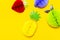 Flat lay bright tropical fruits of paper, strawberry, pineapple, apple, plum on yellow background top view copy space.