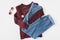 flat lay with burgundy knitted sweater, trendy jeans and accessories,