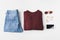 flat lay with burgundy knitted sweater, trendy jeans, accessories and smartphone,