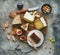 Flat-lay of cheese assortment, figs, honey and nuts