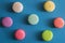 Flat lay. Close up. Colorful pastry french macarons. Blue background