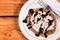 Flat lay closeup macro american pancake with cream colorful sprinkles and topped chocolate cream