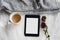 Flat lay of coffee, dried leaves and blank tablet