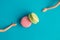 Flat lay of colorful macarons and doll hands abstract concept.