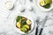 Flat lay composition with avocado toasts on marble table