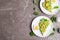 Flat lay composition with avocado toasts on marble table, space for text