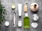 Flat lay composition of bath accessories and cosmetics on gray background