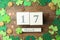 Flat lay composition with block calendar on background. St. Patrick`s Day celebration
