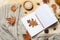 Flat lay composition with book, autumn leaves and warm blanket on fuzzy rug.