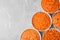 Flat lay composition with bowls of differently cut carrots on marble background