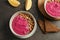 Flat lay composition with bowls of tasty beet hummus, slices of bread and lemon